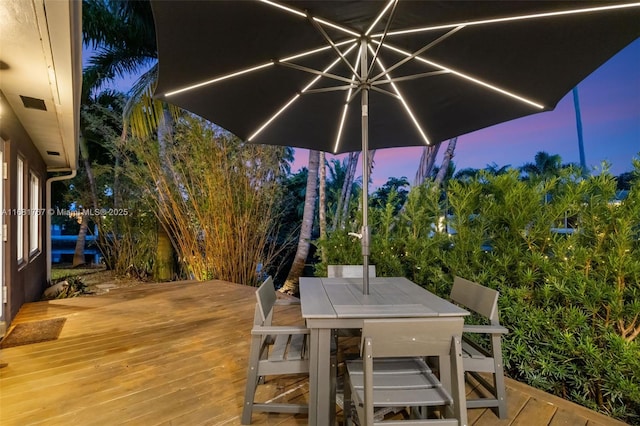 wooden terrace featuring outdoor dining space