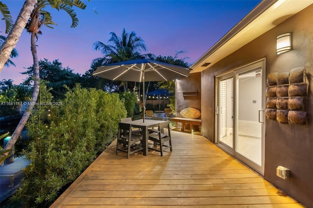 wooden terrace featuring outdoor dining space