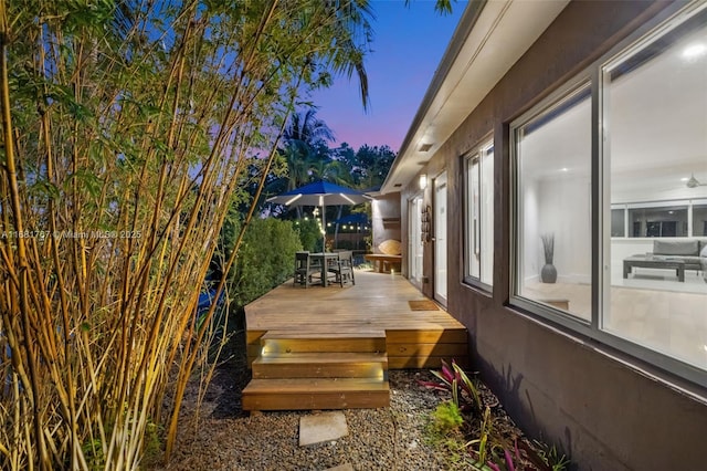 wooden terrace with outdoor dining space