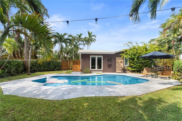 view of swimming pool with a patio, fence, a fenced in pool, and a yard