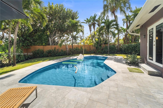 view of swimming pool featuring entry steps, a fenced backyard, a fenced in pool, and a patio