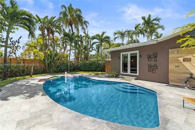 view of swimming pool with a fenced in pool, a fenced backyard, and a patio