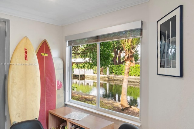 doorway featuring ornamental molding and a water view