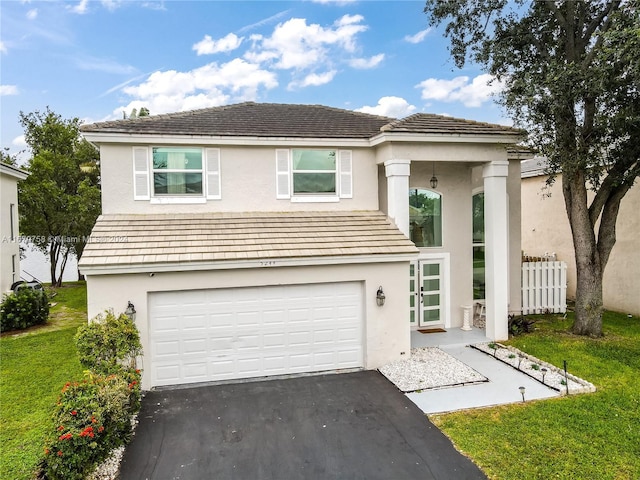 front of property featuring a garage and a front lawn