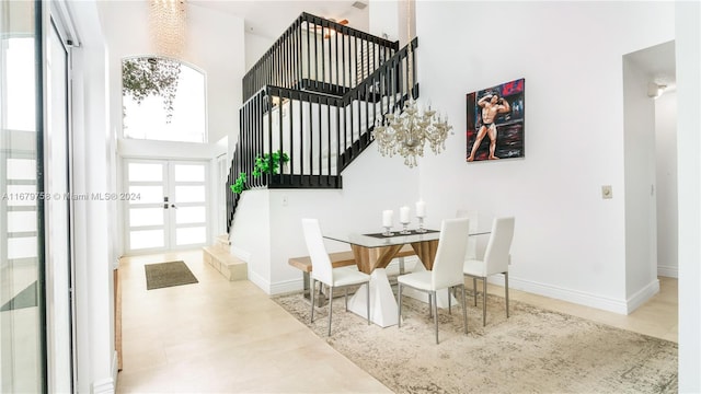 dining space featuring french doors and a towering ceiling