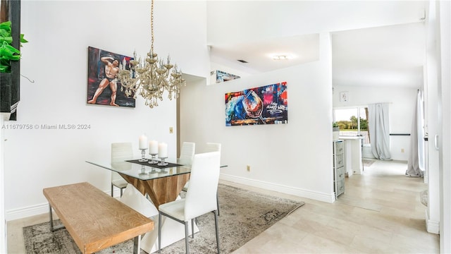 dining room featuring high vaulted ceiling and a notable chandelier