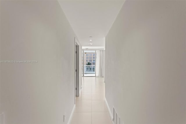 hall with light tile patterned floors