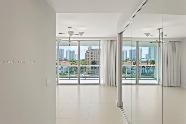 unfurnished room featuring light tile patterned flooring and floor to ceiling windows