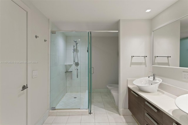 bathroom with a shower with door, vanity, toilet, and tile patterned flooring