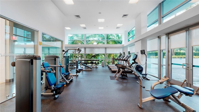 workout area with a high ceiling