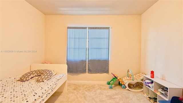 bedroom featuring light carpet