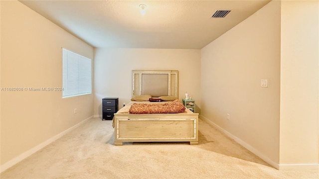 bedroom featuring light carpet