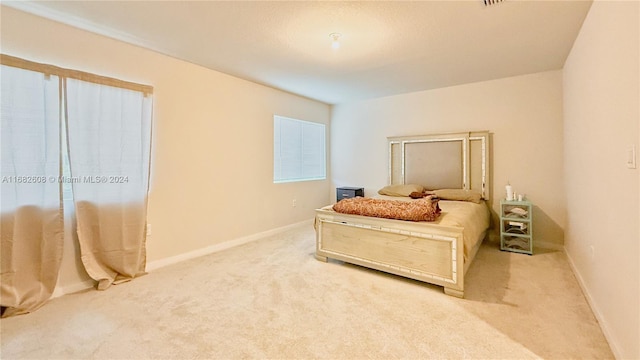 bedroom featuring light colored carpet