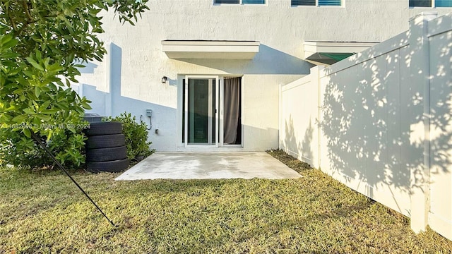 back of property featuring a yard and a patio