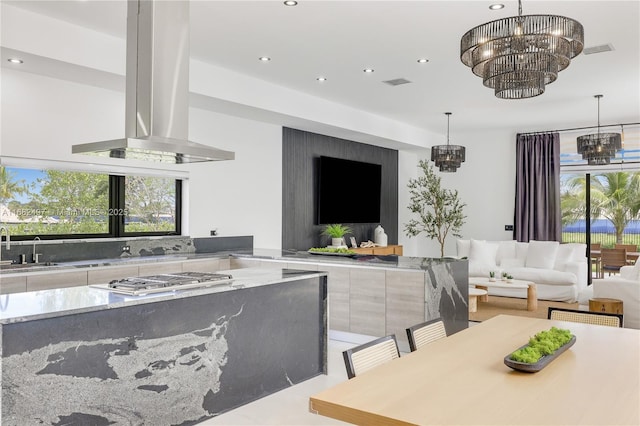 kitchen with pendant lighting, visible vents, a notable chandelier, and island exhaust hood