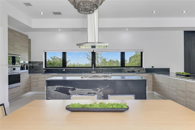 kitchen featuring appliances with stainless steel finishes, a healthy amount of sunlight, visible vents, and modern cabinets