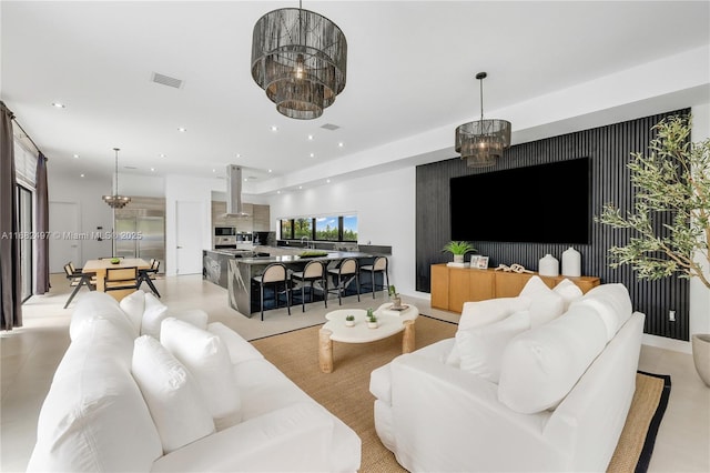 living room with visible vents, a notable chandelier, and recessed lighting