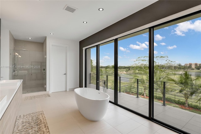 bathroom with visible vents, vanity, a freestanding tub, a shower stall, and recessed lighting