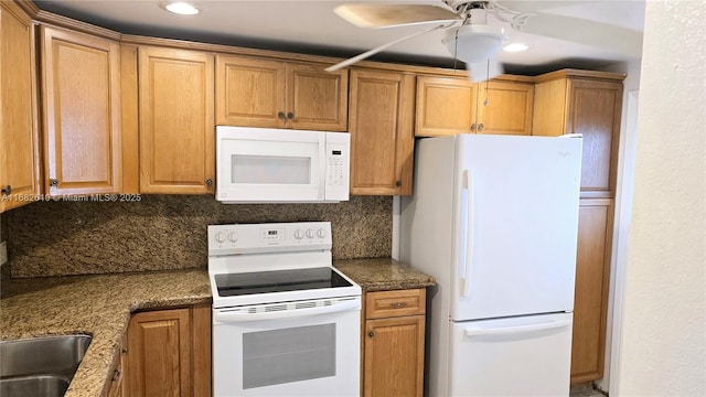 kitchen with tasteful backsplash, ceiling fan, and white appliances