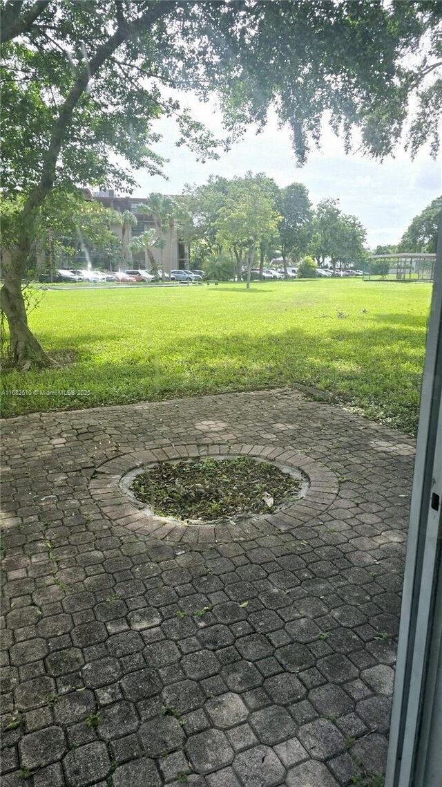 view of community featuring a yard and a patio