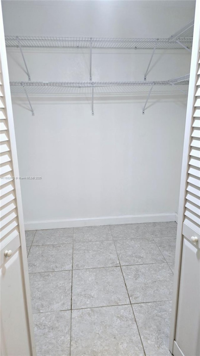 spacious closet with light tile patterned flooring