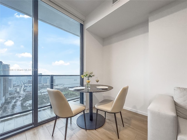 dining space featuring hardwood / wood-style flooring and floor to ceiling windows