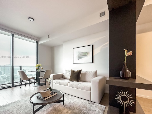 living room featuring light hardwood / wood-style flooring and floor to ceiling windows