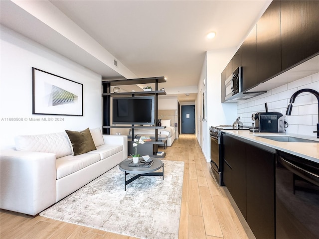 living room with light hardwood / wood-style flooring and sink