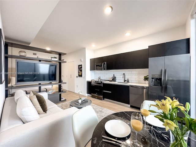 living room with sink and light hardwood / wood-style flooring