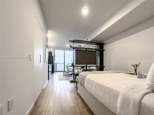 bedroom featuring hardwood / wood-style flooring and floor to ceiling windows