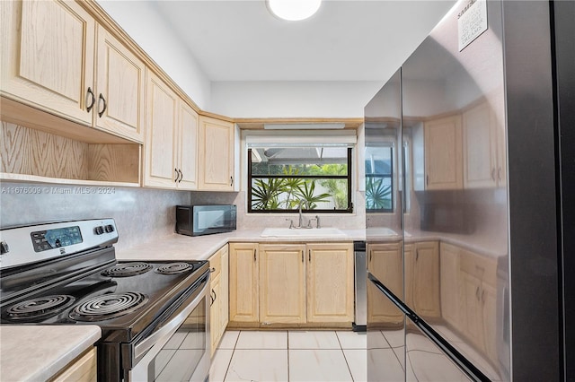 kitchen with tasteful backsplash, light brown cabinets, stainless steel appliances, and sink