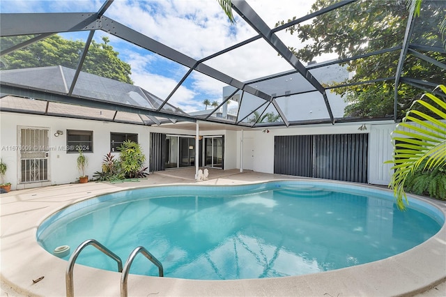 view of pool featuring a patio and glass enclosure