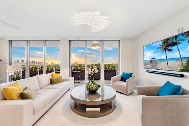 living room with floor to ceiling windows and carpet