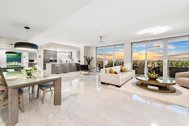 living room with expansive windows and marble finish floor