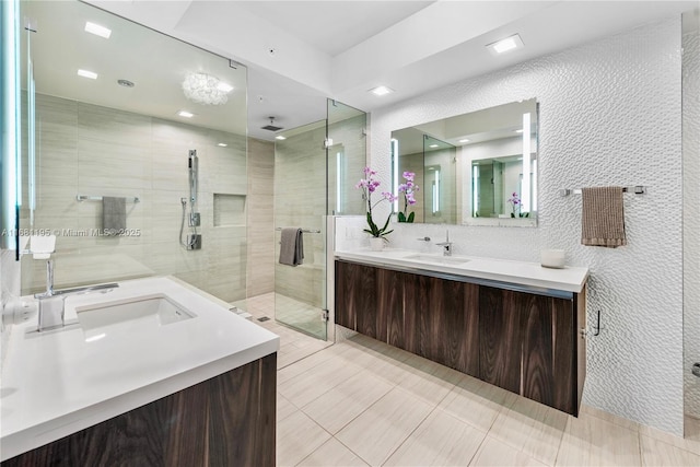 full bath featuring a stall shower, vanity, and tile patterned floors