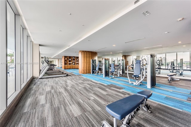 gym with carpet flooring, visible vents, and floor to ceiling windows