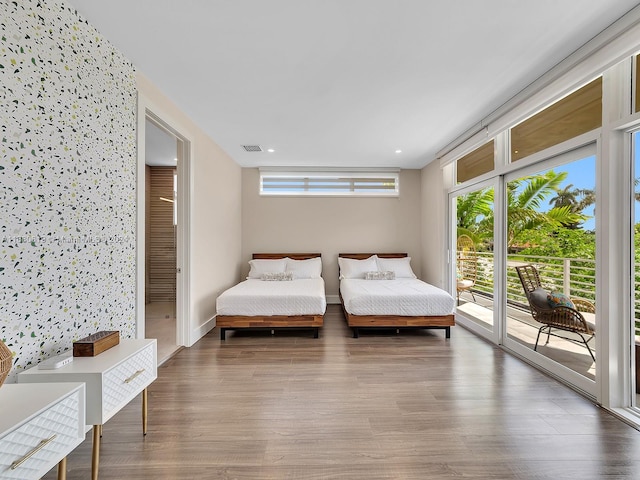 bedroom featuring hardwood / wood-style flooring and access to outside