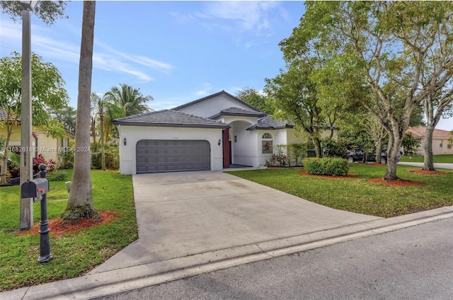 view of front of property featuring a garage and a front yard