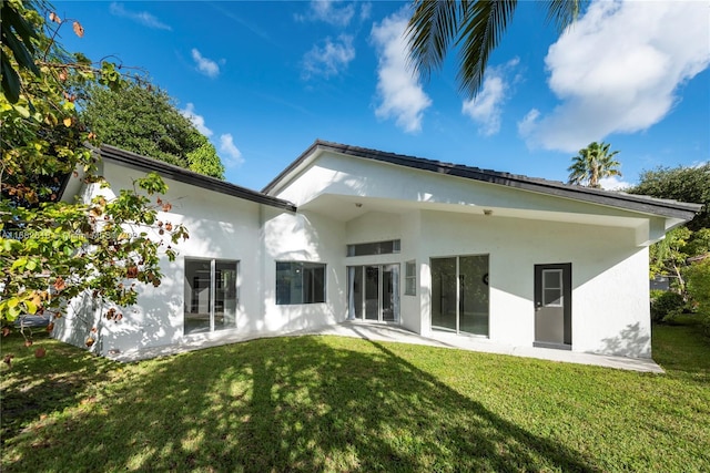 rear view of property featuring a yard