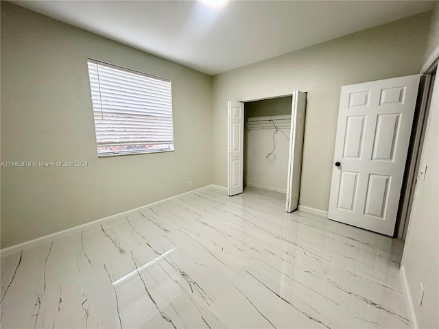 unfurnished bedroom with a closet