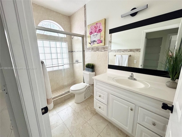 bathroom with vanity, tile patterned flooring, toilet, tile walls, and an enclosed shower