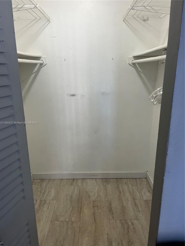 walk in closet featuring light hardwood / wood-style flooring