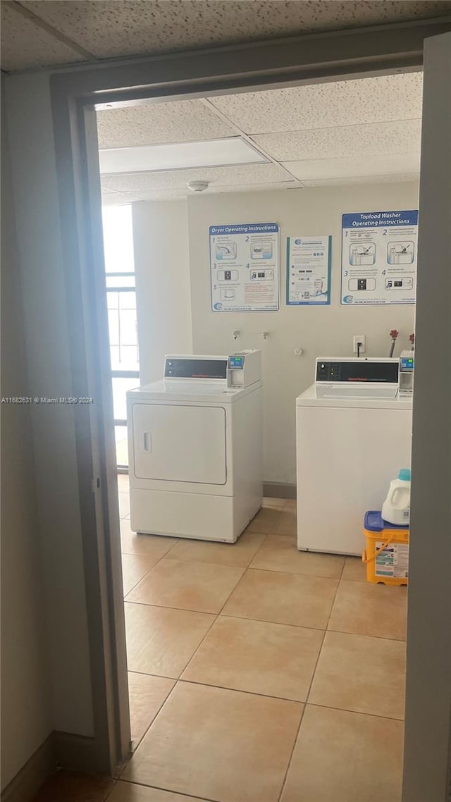 washroom with separate washer and dryer and tile patterned flooring