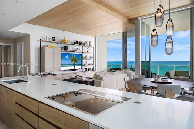 kitchen featuring sink, wooden ceiling, and pendant lighting