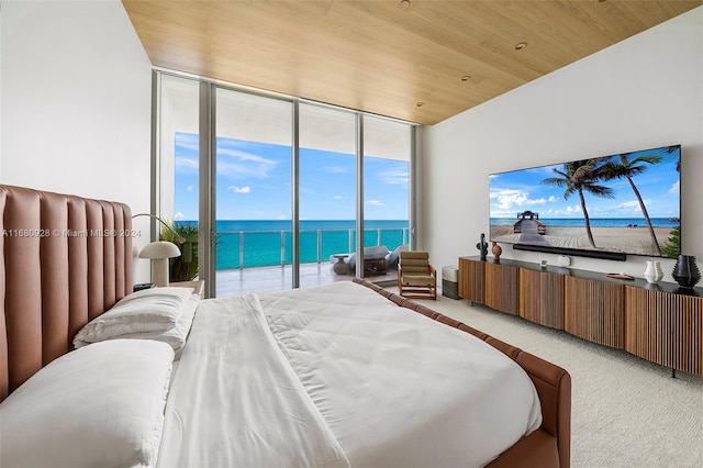 carpeted bedroom with wooden ceiling, multiple windows, expansive windows, and access to exterior