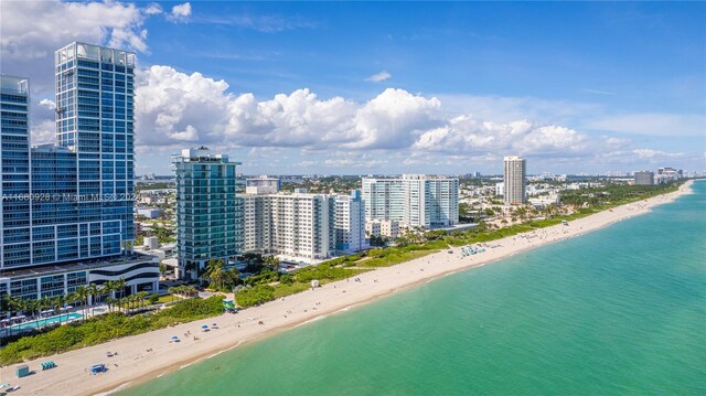 drone / aerial view featuring a view of the beach and a water view