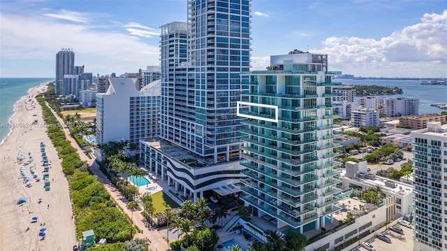 property's view of city featuring a water view and a view of the beach