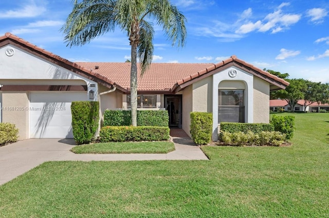 view of front of house featuring a garage and a front lawn