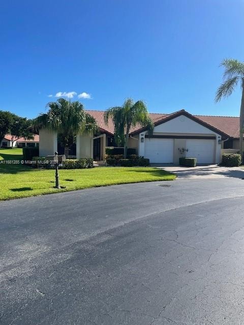 ranch-style house with a front lawn and a garage