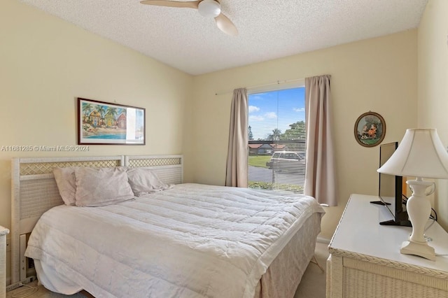 bedroom with a textured ceiling and ceiling fan